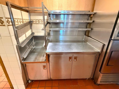 64" WIDE X 30" CUSTOM FABRICATED COMMERCIAL STAINLESS STEEL WORKSTATION WITH TWO-SECTION BASE CABINET, STAINLESS STEEL WORK SURFACES, RAISED BACK AND SIDE SPLASHES, OVERHEAD MULTI-TIER SHELVING AND ENCLOSED STORAGE WITH INTERIOR SHELVES.