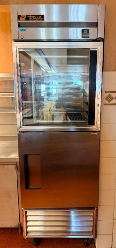 TRUE ONE-SECTION REACH-IN REFRIGERATOR WITH STAINLESS STEEL EXTERIOR, UPPER GLASS DISPLAY DOOR, LOWER SOLID DOOR, INTERIOR PAN/RACK SLIDES, BOTTOM-MOUNT REFRIGERATION SYSTEM AND TOP-MOUNTED TRUE TEMPERATURE CONTROL ASSEMBLY.