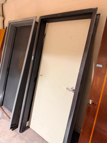 (2) METAL SECURITY DOORS W/ FRAMES.
