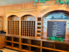 24' LONG CUSTOM-BUILT SOLID OAK BAR AND BACK BAR ASSEMBLY WITH RAISED-PANEL CABINETRY, DECORATIVE MOLDING, CARVED ACCENTS, ARCHED BACK-BAR SECTIONS, MULTIPLE WINE BOTTLE STORAGE CUBBIES, OPEN SHELVING, LOWER STORAGE COMPARTMENTS, SERVICE COUNTER, AND TRIP - 11