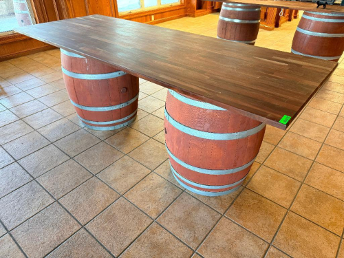 8' X 36" CUSTOM-BUILT SOLID WOOD TABLE WITH THICK BUTCHER-BLOCK STYLE RECTANGULAR TOP AND (2) WOOD WINE BARREL BASES WITH METAL HOOPS.