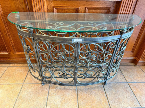 48" W X 17" D DECORATIVE WROUGHT IRON DEMILUNE CONSOLE TABLE BASE WITH ORNATE SCROLLWORK, ACANTHUS LEAF ACCENTS, PINECONE FINIALS AND CURVED FRONT. OPEN METAL FRAME CONSTRUCTION WITH DECORATIVE FRONT AND SIDE PANELS. COMES W/ GLASS TOP.