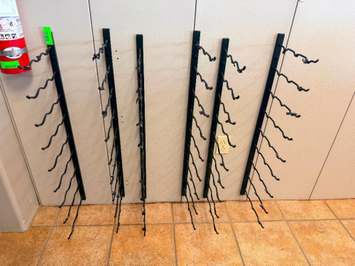 LOT OF (7) WALL-MOUNT WINE BOTTLE DISPLAY RACKS WITH BLACK METAL VERTICAL SUPPORTS AND INDIVIDUAL WAVED BOTTLE-HOLDING ARMS.