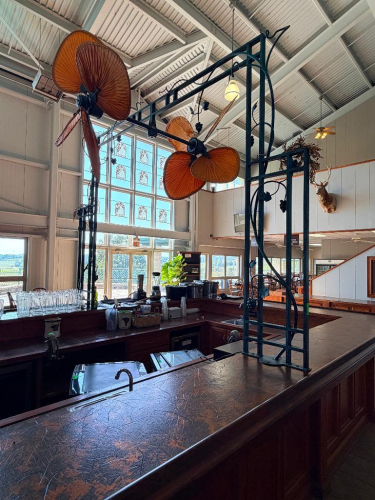 (1) FANTIMATION PALISADE DUAL-MOTOR CEILING FANS WITH LARGE TROPICAL-STYLE WOVEN LEAF BLADES, MOUNTED TO DECORATIVE METAL OVERHEAD FRAMEWORK