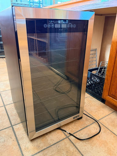 NEWAIR FREESTANDING DUAL-ZONE WINE COOLER WITH STAINLESS STEEL TRIM, TINTED GLASS DOOR, DIGITAL TEMPERATURE CONTROLS, AND REMOVABLE WIRE WINE RACKS.