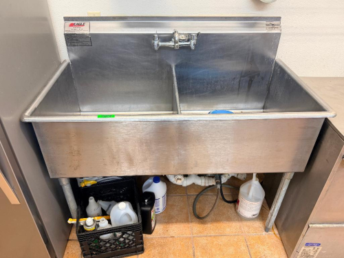 50" W X 25" EAGLE SINKS STAINLESS STEEL TWO-COMPARTMENT COMMERCIAL SINK WITH INTEGRAL BACKSPLASH, WALL-MOUNT FAUCET, DIVIDED DEEP BASINS, AND GALVANIZED LEGS.