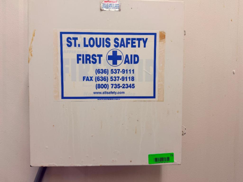FIRST AID KIT AND WALL MOUNTED READER BOARD.