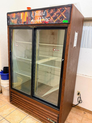 TRUE TWO-DOOR GLASS MERCHANDISER REFRIGERATOR WITH SLIDING GLASS DOORS, WOODGRAIN EXTERIOR FINISH, INTERIOR WIRE SHELVING, BOTTOM-MOUNT REFRIGERATION SYSTEM, AND ILLUMINATED &ldquo;CHILLED WINE&rdquo; TOP SIGN.