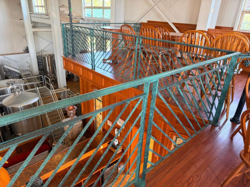 40 LINEAR FT OF CUSTOM DECORATIVE METAL SAFETY RAILING WITH DIAGONAL BAR PATTERN, GRAPE AND VINE ACCENTS, TOP AND BOTTOM RAILS, AND FLOOR-MOUNTED POSTS. GREEN TEXTURED FINISH.