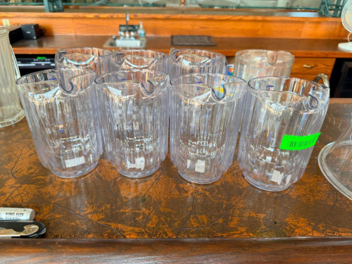 (8) 64 OZ PLASTIC PITCHERS.