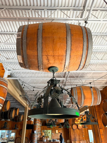 DECORATIVE HANGING WOODEN BARREL LIGHT FIXTURE WITH METAL HOOPS, CIRCULAR METAL LIGHT FRAME, AND DECORATIVE GRAPE VINE, LEAF, AND GRAPE CLUSTER ACCENTS. 20" SHADE.