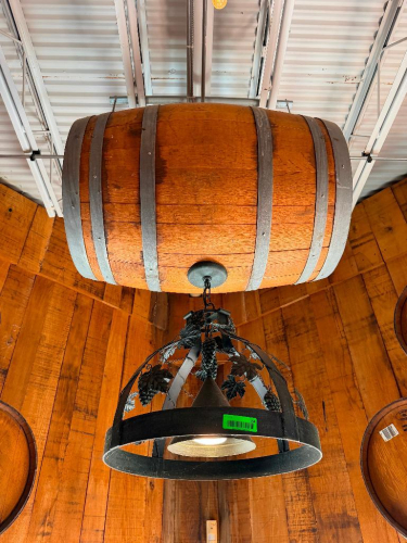 DECORATIVE HANGING WOODEN BARREL LIGHT FIXTURE WITH METAL HOOPS, CIRCULAR METAL LIGHT FRAME, AND DECORATIVE GRAPE VINE, LEAF, AND GRAPE CLUSTER ACCENTS. 20" SHADE.