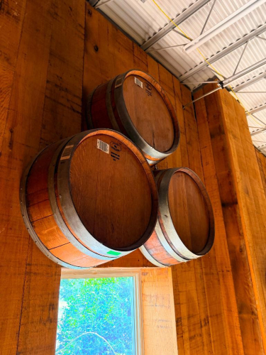 (3) WOOD WINE BARRELS MOUNTED HORIZONTALLY TO WALL, WITH WOOD STAVE CONSTRUCTION AND METAL HOOPS.