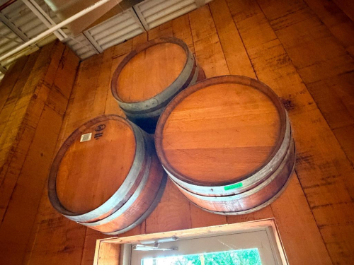 (3) WOOD WINE BARRELS MOUNTED HORIZONTALLY TO WALL, WITH WOOD STAVE CONSTRUCTION AND METAL HOOPS.