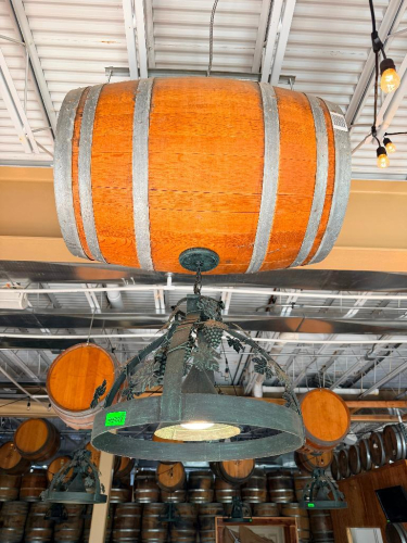 DECORATIVE HANGING WOODEN BARREL LIGHT FIXTURE WITH METAL HOOPS, CIRCULAR METAL LIGHT FRAME, AND DECORATIVE GRAPE VINE, LEAF, AND GRAPE CLUSTER ACCENTS. 20" SHADE.
