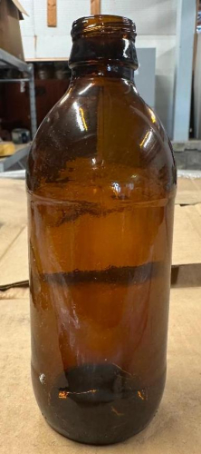 (1) PALLET OF GLASS BEER BOTTLES. (5) ROWS STACKED AND WRAPPED ON A PALLET.