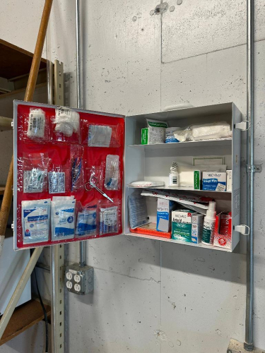 WALL MOUNTED FIRST AID CABINET.