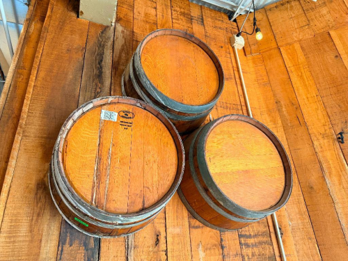(3) WOOD WINE BARRELS MOUNTED HORIZONTALLY TO WALL, WITH WOOD STAVE CONSTRUCTION AND METAL HOOPS.