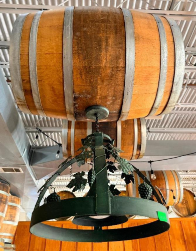 DECORATIVE HANGING WOODEN BARREL LIGHT FIXTURE WITH METAL HOOPS, CIRCULAR METAL LIGHT FRAME, AND DECORATIVE GRAPE VINE, LEAF, AND GRAPE CLUSTER ACCENTS. 20" SHADE.