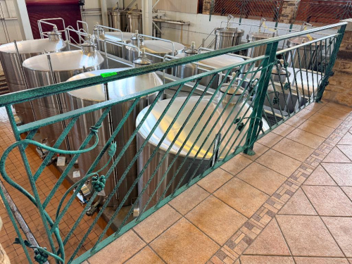 60 LINEAR FT OF CUSTOM DECORATIVE METAL SAFETY RAILING WITH DIAGONAL BAR PATTERN, GRAPE AND VINE ACCENTS, TOP AND BOTTOM RAILS, AND FLOOR-MOUNTED POSTS. GREEN TEXTURED FINISH.