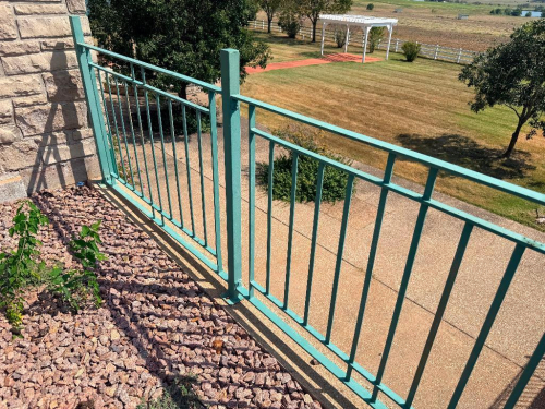 APPROX. 100 LINEAR FT. OF CUSTOM FABRICATED METAL RAILING WITH STAIR RAILING SECTIONS, VERTICAL PICKET DESIGN, SQUARE POSTS, TOP RAILS AND MOUNTING BASE PLATES. GREEN PAINTED FINISH. INCLUDES STRAIGHT RUN AND SLOPED STAIR SECTIONS.