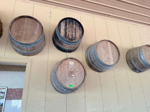 (5) WOOD WINE BARRELS MOUNTED HORIZONTALLY TO WALL, WITH WOOD STAVE CONSTRUCTION AND METAL HOOPS.