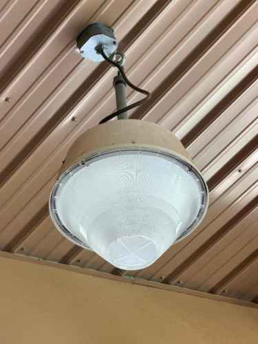 (6) COMMERCIAL SUSPENDED CEILING LIGHT FIXTURE WITH ROUND HOUSING AND PRISMATIC REFRACTOR LENS.