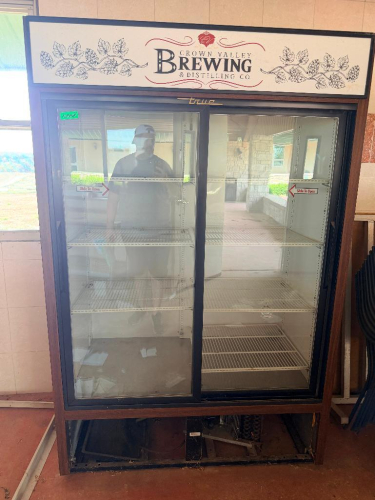 TRUE TWO-SECTION COMMERCIAL GLASS DOOR MERCHANDISER REFRIGERATOR WITH (2) SLIDING GLASS DOORS, ADJUSTABLE WIRE SHELVING, INTERIOR LIGHTING AND CUSTOM CROWN VALLEY BREWING & DISTILLING CO. HEADER AND WOOD-LOOK EXTERIOR TRIM.