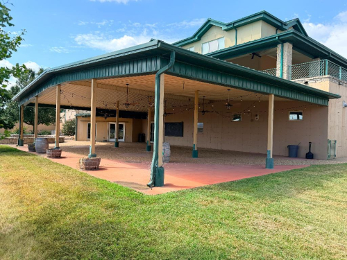 APPROX. 42' X 64' LARGE COVERED PATIO / PAVILION STRUCTURE WITH METAL ROOF, METAL FASCIA, GUTTER SYSTEM, SUPPORT POSTS AND METAL SOFFIT CEILING.