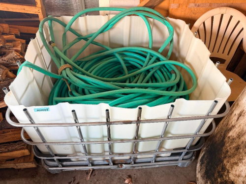 PLASTIC TOTE W/ LANDSCAPING HOSE. APPROX 200'