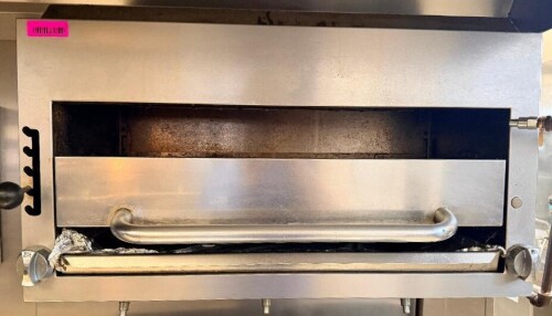 COMMERCIAL GAS SALAMANDER BROILER WITH STAINLESS STEEL EXTERIOR, ADJUSTABLE-HEIGHT BROILER RACK, LARGE FRONT HANDLE, DUAL GAS CONTROLS, AND REMOVABLE LOWER DRIP/CRUMB TRAY.