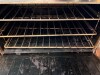 GARLAND COMMERCIAL GAS RANGE WITH FOUR OPEN TOP BURNERS AND STANDARD OVEN BASE. FEATURES HEAVY CAST-IRON BURNER GRATES, STAINLESS STEEL FRONT AND SIDES, REAR FLUE RISER, OVEN DOOR WITH FULL-WIDTH HANDLE, AND MULTIPLE OVEN RACKS. - 3