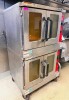 VULCAN DOUBLE-STACK COMMERCIAL CONVECTION OVEN WITH TWO INDEPENDENT OVEN COMPARTMENTS, STAINLESS STEEL EXTERIOR, DOUBLE GLASS VIEWING DOORS, ADJUSTABLE WIRE RACKS, FORCED-AIR CONVECTION FANS, INDIVIDUAL TEMPERATURE CONTROLS, TIMERS, AND MOBILE CASTER BASE