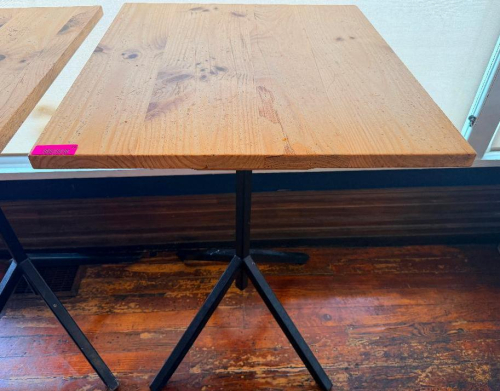 32" WIDE X 24" PINE PUB TABLE WITH THICK SOLID WOOD TOP AND BLACK METAL PEDESTAL BASE. RECTANGULAR TOP FEATURES VISIBLE NATURAL KNOTS AND WOOD GRAIN WITH A CLEAR/NATURAL FINISH.