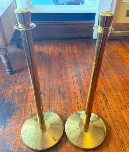 (5) BRASS COLORED HEAVY DUTY STANCHION POSTS W/ RED VELVET ROPE.