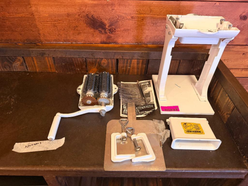 WESTON MANUAL MEAT CUBER / TENDERIZER WITH HAND-CRANK DRIVE, INTERLOCKING STAINLESS STEEL CUTTING BLADE ASSEMBLY, COUNTERTOP STAND, FEED CHUTE, MOUNTING HARDWARE, AND ACCESSORIES. DISASSEMBLED AS SHOWN