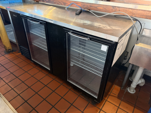 TURBO AIR THREE-DOOR COMMERCIAL BACK BAR REFRIGERATOR WITH BLACK EXTERIOR, STAINLESS STEEL TOP, THREE GLASS SWING DOORS, AND ADJUSTABLE WIRE SHELVING