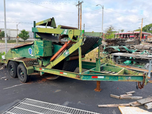 TRAILER-MOUNTED INDUSTRIAL MATERIAL SCREENING / SEPARATION SYSTEM WITH INCLINED HEAVY-DUTY CLEATED CONVEYOR, FEED HOPPER, HYDRAULIC LIFT CYLINDER, ENGINE-DRIVEN HYDRAULIC SYSTEM, DISCHARGE CHUTE, TANDEM-AXLE TRAILER, SAFETY CHAINS, AND JACK. UNIT SHOWS HE