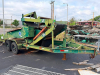 TRAILER-MOUNTED INDUSTRIAL MATERIAL SCREENING / SEPARATION SYSTEM WITH INCLINED HEAVY-DUTY CLEATED CONVEYOR, FEED HOPPER, HYDRAULIC LIFT CYLINDER, ENGINE-DRIVEN HYDRAULIC SYSTEM, DISCHARGE CHUTE, TANDEM-AXLE TRAILER, SAFETY CHAINS, AND JACK. UNIT SHOWS HE