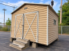 MORGAN PREFABRICATED METAL STORAGE BUILDING WITH GABLE ROOF, DOUBLE FRONT SWING DOORS, METAL SIDING, METAL ROOFING, SIDE WINDOWS/VENTS, AND STEEL FRAMING. BUILDING IS CURRENTLY ELEVATED ON CONCRETE BLOCKS. CONCRETE STEPS AND FIRE EXTINGUISHER
