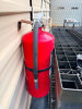 MORGAN PREFABRICATED METAL STORAGE BUILDING WITH GABLE ROOF, DOUBLE FRONT SWING DOORS, METAL SIDING, METAL ROOFING, SIDE WINDOWS/VENTS, AND STEEL FRAMING. BUILDING IS CURRENTLY ELEVATED ON CONCRETE BLOCKS. CONCRETE STEPS AND FIRE EXTINGUISHER - 4