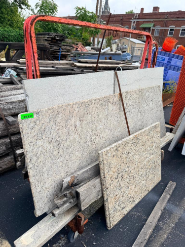 ASSORTED GRANITE AND STONE COUNTERTOP SLABS AND CUT SECTIONS WITH MULTIPLE COLORS AND PATTERNS. LOT INCLUDES FULL AND PARTIAL SLABS WITH FINISHED AND UNFINISHED EDGES. CONTENTS AS SHOWN.