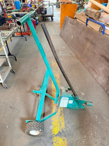 GREENLEE 1800 MECHANICAL CONDUIT BENDER WITH LONG MANUAL LEVER, WHEELED TRANSPORT FRAME, BENDING SHOE, DEGREE/BEND MARKINGS, AND INTEGRATED FOOT PLATFORM.