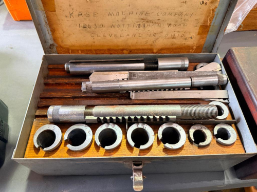 KASE MACHINE COMPANY KEYWAY BROACH SET WITH MULTIPLE PUSH-TYPE BROACHES, SLOTTED GUIDE BUSHINGS, SHIMS, AND FITTED WOOD STORAGE INSERT IN A METAL CARRYING CASE.