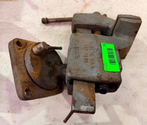 HEAVY-DUTY SWIVEL BASE BENCH VISE WITH CAST METAL BODY, DUAL JAWS, SCREW-TYPE CLAMPING MECHANISM, LOCKING HANDLES AND ROTATING BASE.