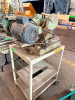 HEAVY-DUTY ABRASIVE CUT-OFF SAW WITH BELT-DRIVEN ELECTRIC MOTOR, ENCLOSED BLADE GUARD, PIVOTING CUTTING HEAD, ROUND WORK TABLE AND MATERIAL VISE / CLAMP ASSEMBLY. MOUNTED ON STEEL ROLLING STAND. - 2