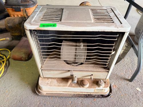 PANACO PORTABLE KEROSENE-FIRED FORCED-AIR SPACE HEATER WITH METAL CABINET, FRONT SAFETY GRILLE, INTERNAL FAN, FUEL TANK BASE, AND ADJUSTABLE HEAT CONTROL.