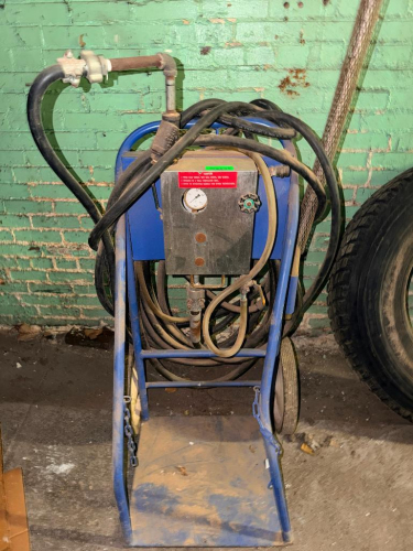 PORTABLE PRESSURE WASHER / STEAM CLEANER UNIT WITH WHEELED STEEL CART, PRESSURE GAUGE, CONTROL VALVE, HIGH-PRESSURE HOSES, PIPING, SPRAY WAND AND WIDE FAN-STYLE SPRAY NOZZLE.