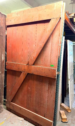 LARGE HEAVY-DUTY WOOD PLANK DOOR WITH VERTICAL BOARD CONSTRUCTION, HORIZONTAL WOOD CROSS BRACING AND DIAGONAL Z-BRACE SUPPORT.