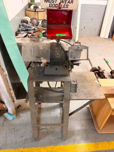VINTAGE INDUSTRIAL DOUBLE-END BENCH GRINDER WITH DUAL GRINDING WHEELS, ADJUSTABLE TOOL RESTS, SAFETY SHIELDS AND HEAVY STEEL FLOOR STAND WITH SIDE WORK SHELF.